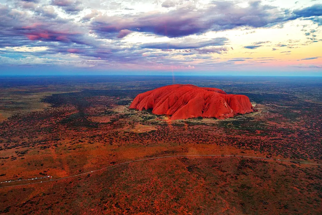Aerial view of Uluru at sunset showing its scale