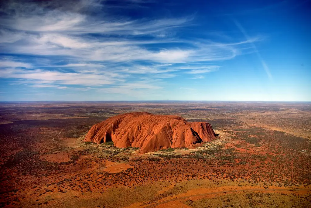 Uluru from a helicopter with Mount Conner on the horizon