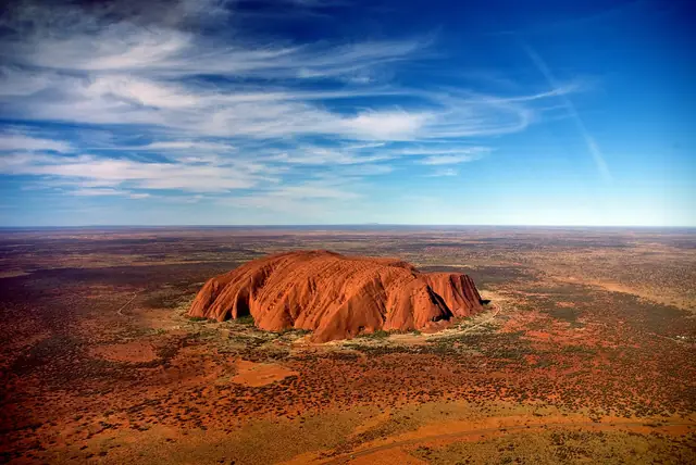 Uluru from a helicopter, with Mount Conner in the distance