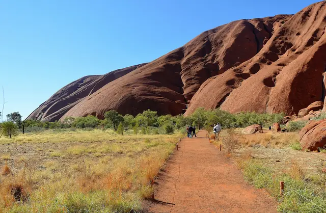 The Mala Walk path running beside the sheer red flank of Uluru
