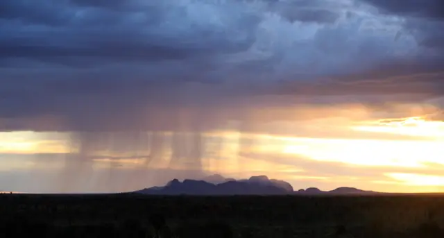 Dark storm clouds gathering over the domes of Kata Tjuta