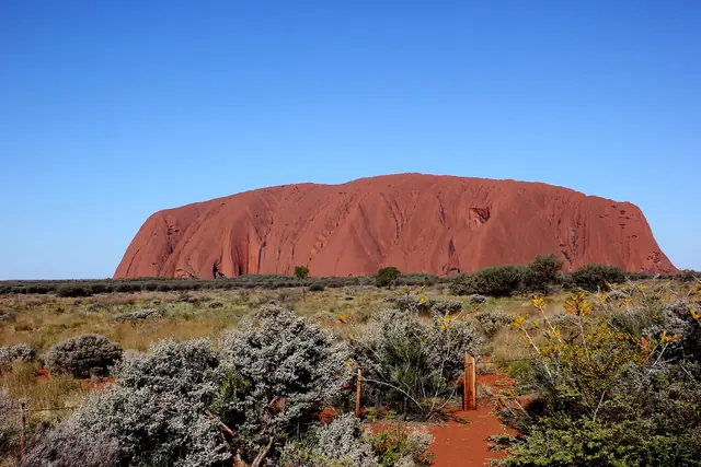 Uluru under a clear desert sky