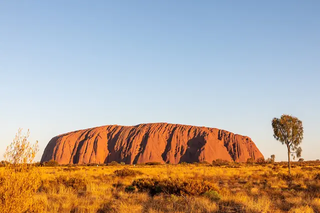 Uluru rising above the desert plain in Uluru-Kata Tjuta National Park